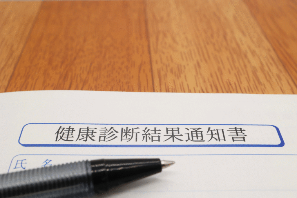 健康診断結果通知書のタイトルが見える状態で、ペンが置かれている