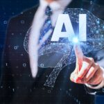 スーツ姿の男性がAI（人工知能）のホログラムに触れている未来的なイメージ